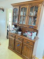 Full view of oak hutch china cabinet showing glass doors, drawers, cabinet doors and hardware