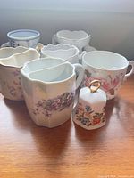 Group shot showing front bell and several floral porcelain cups
