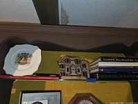 Coronation plate, ceramic tile and book stack overview
