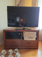 Overall view of Samsung TV on brown media console