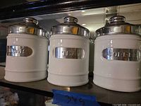Front view of all three labeled canisters on shelf