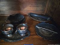Group shot showing all silver-plated items on shelf