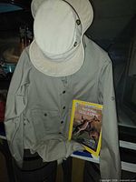 Hat resting on safari jacket with magazine displayed