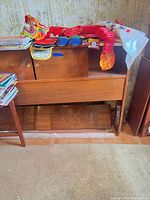 Front view of piano frame with front board installed, stacked books and decorations on top