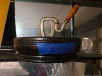 Side view of vise and round wood base