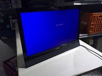 Front view of Vizio TV powered on showing blue "No Signal" screen