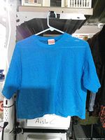 Front view of blue mesh top on hanger