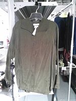 Front view of Avery Quinn sable silk button-front blouse on hanger