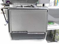 Front view of closed projector case showing speaker grille and branding