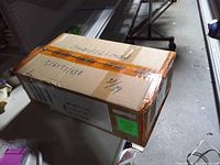 Closed shipping carton showing labels and tape