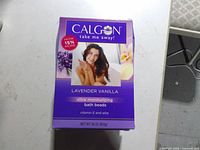 Front view of one Calgon Lavender Vanilla bath beads box showing product details