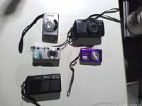 Front view of all five cameras showing brands and colors