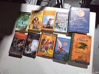 Front covers of all ten novels laid out, showing titles and authors where visible