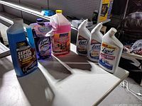 All seven cleaning products grouped on table