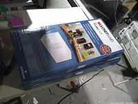 Two sealed ClosetMaid Cubeicals boxes on table