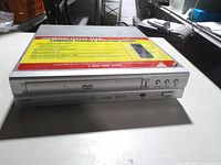 Front view showing disc tray, brand marking and control buttons