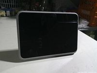 Front view of Meta Portal Go smart display showing black touchscreen and grey fabric bezel