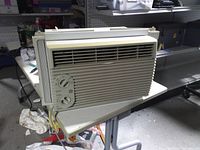 Front view showing grille, control panel, side panels