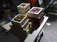 Stacked boxed ornament sets on table showing variety of boxes and window fronts