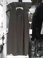 Full view of brown sleeveless top on hanger