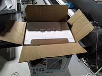 Open shipping carton showing foam insert and air purifier body beneath