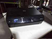 Front and top view of HP Envy 4500 printer powered on