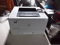 Front and right side view of HP LaserJet Pro M402n printer on table