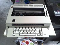 Front view showing full keyboard, paper feed area