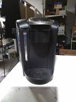 Front view of Keurig brewer showing water reservoir and drip tray
