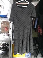 Front view of gray polka-dot dress on hanger
