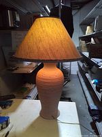 Full view of lamp on tabletop showing base and shade