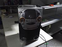 Front view of Memorex karaoke system showing screen, controls and speakers