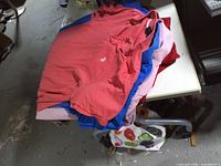 Stack of five assorted-colour polo shirts