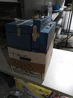 Box of blue slide cases viewed from front side