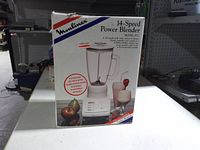 Front of sealed box showing image of blender and model details
