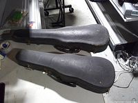 Two closed black textured violin cases