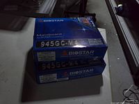 Stacked Biostar 945GC-M4 motherboard boxes