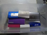 Top view of bin containing six visible power banks in various colours