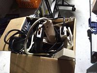 Box filled with tangled power strips viewed from top