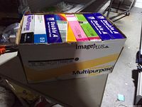 Box showing assorted sealed reams inside