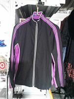 Front view of jacket on hanger showing color scheme and zipper