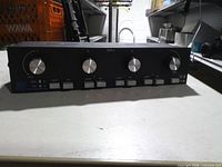 Front view showing four volume knobs, push buttons, model marking SDA-4