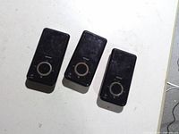 Front view of three identical SanDisk Sansa MP3 players