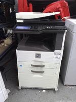 Front view of Sharp MX-M264 copier showing entire unit and drawers