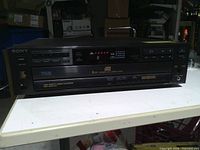 Front view showing Sony branding, 5-disc carousel drawer, controls and display