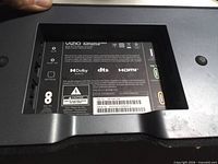 Close-up of Vizio label and input bay on one sound bar