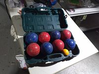 open Spalding case showing 8 bocce balls and pallino