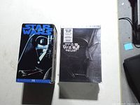 Front view of VHS and sealed DVD box sets side by side