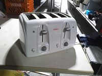 Front view showing Sunbeam branding, dual control panels and four slots