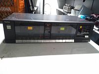 Front view of Technics dual cassette deck with both tape wells, controls, and display